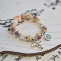 Elegant vintage Jingdezhen ceramic beaded bracelet featuring metal bow and coin charm - Fairy Has Mine (1011-01) / Purple