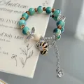 Vintage style turquoise crackle glaze ceramic beaded bracelet with silver flower charms - Buzhou Mountain (1039-01) / Cyan Blue