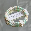 Elegant mint green ceramic beaded bracelet with star and cross charms on a white card - 1075-08 Pomelo Sweetheart Style