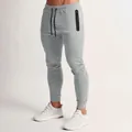 Pantalones de chándal gris claro para hombre ajustados con bolsillo con cremallera gym - S / Bottoms / Gris