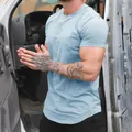 Close-up detail showing the fabric and muscle fit of this light blue men fitness t-shirt - M / Tops / Light Blue