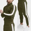 Detailed view of white side stripes on olive green tracksuit with stand collar. - L / Top And Bottom / Olive Green And White