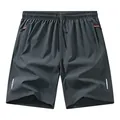 Dunkelgraue Sportshorts mit reflektierenden Streifen und orangefarbenen Reißverschlussdetails - XS / Bottoms / Dunkelgrau