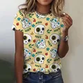 Women's yellow t-shirt with a cute cartoon sugar skull and floral pattern for Day of the Dead - XXS / Tops / Light Yellow