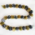 Detailed view of silver and gold marigold pom pom garland for festive party decor - No.26 Silver Gray and Brown