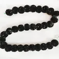 Detailed view of black plastic marigold garland for Day of the Dead and wedding decor. - No. 18 Black