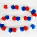 Detailed view of red, white, and blue plastic pom pom garland for festive decorations. - No.21 Red, White and Blue