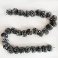 Detailed view of silver plastic marigold garland string for festive event decorations. - No.23 Silver Gray