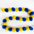 Close-up detail of yellow and blue marigold garland for Indian wedding decorations. - No.27 Blue and Yellow