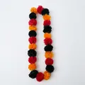 Detail shot of colorful red, orange, and black marigold garland for festive decor - Red Black & Orange Mixed Marigold Garland (CC-LH3) / 24 Flowers/113cm / Red Black and Orange
