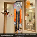 Hanging Frankenstein Halloween decoration with long orange and black stretchable legs - Stretch Zombie