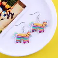 Close-up view of colorful Mexican pinata cartoon earrings for creative festival parties. - Colorful Tassel Piñata Horse