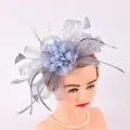 Elegant dusty blue mesh and feather fascinator headband shown on a mannequin head - Gray