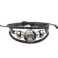 Vue détaillée d'un bracelet en cuir tressé multicouche avec un crâne en sucre coloré. - Style Crâne de Sucre Mexicain (XL0198)