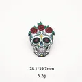 Close-up detail of a colorful Mexican sugar skull enamel pin decorated with red roses - Rose Cross Skull (14)