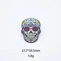Detailed close-up of vibrant Mexican sugar skull enamel pin with floral patterns - Colorful Cross Skull (15)