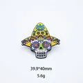 Close-up of Mexican sugar skull enamel brooch with yellow sombrero and colorful patterns - Star Eye Yellow Hat Skull (16)