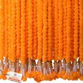 Vibrant orange marigold garlands with golden bells and white fringe for festivals - Style with Bells / Orange