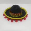 Detailed view of a mini black Mexican sombrero with festive pom-poms and glitter trim. - Black Felt Yellow Trim Red Balls Style (36) / Headband Style