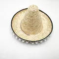 Detailed view of woven straw sombrero featuring white pom-poms and a colorful braided band - M (56-58cm) / Diameter 35cm / Natural Wheat Straw
