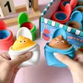 Cute cartoon poo-shaped squeeze toy in white and blue cups for stress relief and fun play. - Toilet Squeeze Cup Squishy