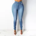 Light blue high waisted skinny denim pencil pants for women showing a slim fit silhouette - S / Bottoms / Medium Blue