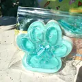 Close-up view showing the sparkling pearl inclusions inside the blue cat paw squishy - Sea Salt Jumbo Cat Paw