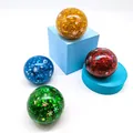 Primo piano di quattro palline antistress glitterate con motivi a fiocco di neve - Pallina Di Paillettes A Forma Di Fiocco Di Neve (un Colore Selezionato Casualmente) / 6cm