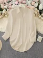 Elegant apricot long sleeve button-down shirt with a unique irregular curved hemline - S / Tops / Apricot