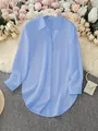 Elegant blue long-sleeve women's shirt featuring asymmetrical hem and silky satin texture - S / Tops / Light Blue