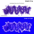 Purple fluorescent star tinsel garland showing bright glow effect under UV light environment - 2 Meters / Fluorescent Macaron Purple