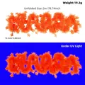 Fluorescent orange star tinsel garland for Christmas tree decor, showing UV glow - 2 Meters / Fluorescent Macaron Orange Red