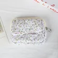 Detailed view of a white floral quilted mini coin purse with snap button pocket - Light Purple Floral