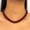 Elegant dark red round bead choker necklace worn on female neck closeup detail view - 10mm Bead / Burgundy