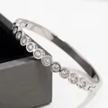 Detailed view of silver stainless steel bangle with round bezel-set cubic zirconia - Round Rhinestone Style (42-E-5) / Silver