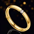 Elegant polished gold titanium steel ring featuring a single sparkling round zirconia stone - Size 7 / Gold