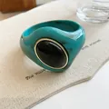 Detailed macro view of chunky marbled turquoise acrylic bangle with black oval stone. - Geometric Open Style (11#)
