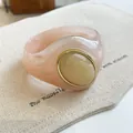 Detailed view of oversized marbled pink acrylic bangle with cream oval cabochon inlay - Geometric Open Style (9#)