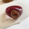 Detailed macro view of a chunky burgundy acrylic bangle featuring a marbled amber resin inlay - Geometric Open Style (8#)
