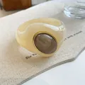 Close-up detail of a marbled acrylic bangle featuring irregular shape and gold frame - Geometric Open Style (6#)