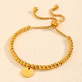 Vue détaillée d'un bracelet en perles d'acier doré avec médaille gravée réglable - Style Lettre O (238224) / Or