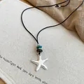 Detailed close-up of a silver starfish pendant necklace with black cord and beads detail - Necklace #3 - Silver - Black - Starfish