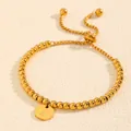 Gros plan d'un bracelet à billes en acier inoxydable doré avec un pendentif initiale lettre Z - Style Lettre Z (238224) / Or