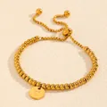 Elegant gold titanium steel bead bracelet featuring an adjustable slide and letter C charm. - Letter C Style (238224) / Gold