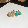 Macro view of gold ring featuring two butterflies with zircons and turquoise enamel - Double Butterfly Design (5#) / Gold Blue