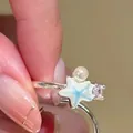 Macro view of a silver ring featuring a blue starfish, pearl, and sparkling zircon - Starfish Theme Combination (30#) / Silver Blue
