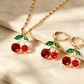 Detailed view of cherry jewelry set with red gems and golden necklace chain - Gold Cherry (5584)