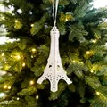 White flocked Eiffel Tower Christmas ornament hanging on tree branches - White Flocked Tower-C