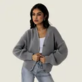 Close-up view of loose grey ribbed knit cardigan with large buttons for autumn winter fashion - S / Tops / Gray