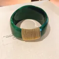 Macro detail of dark green marble-effect acrylic bangle with gold chain wrap - Geometric Open Style (25#)